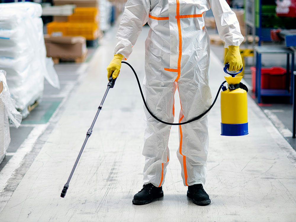 Specialist in protective suit holding spray equipment for asbestos and mould remediation services