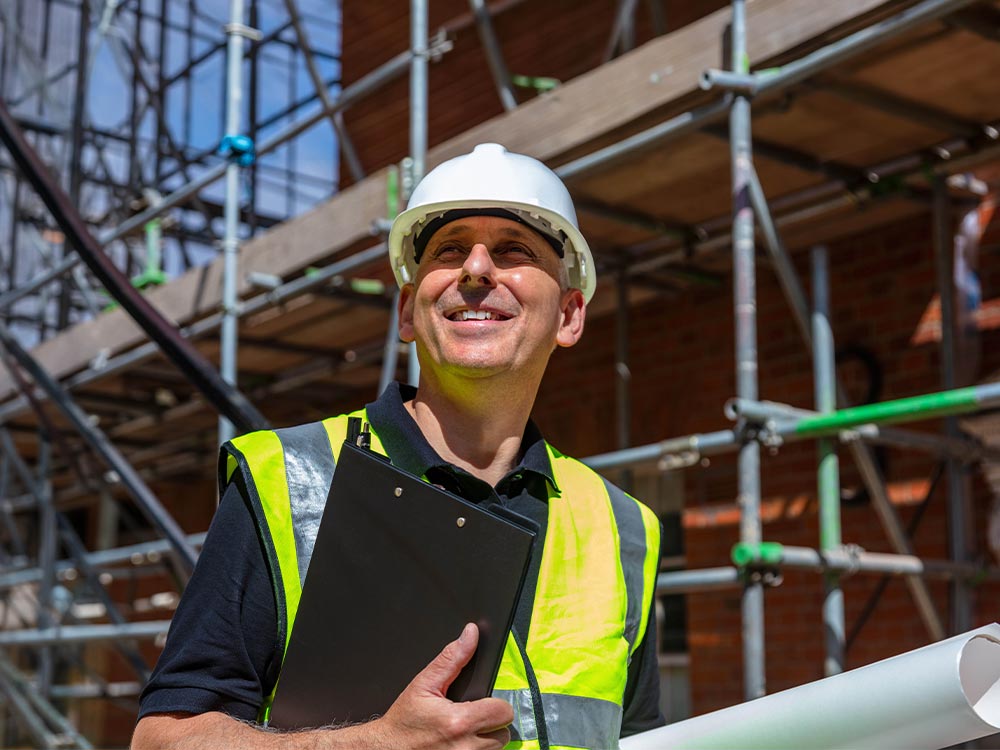 Construction site manager overseeing residential property development and asset management projects