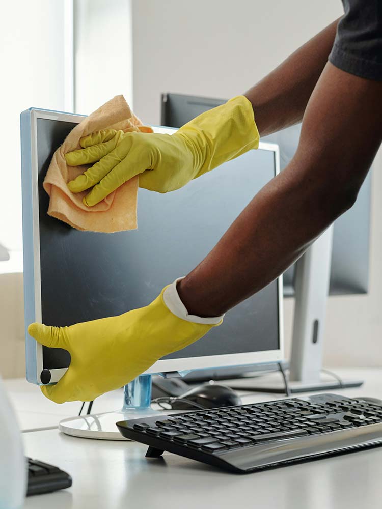 Commercial office cleaning and facility maintenance contractor cleaning workplace equipment