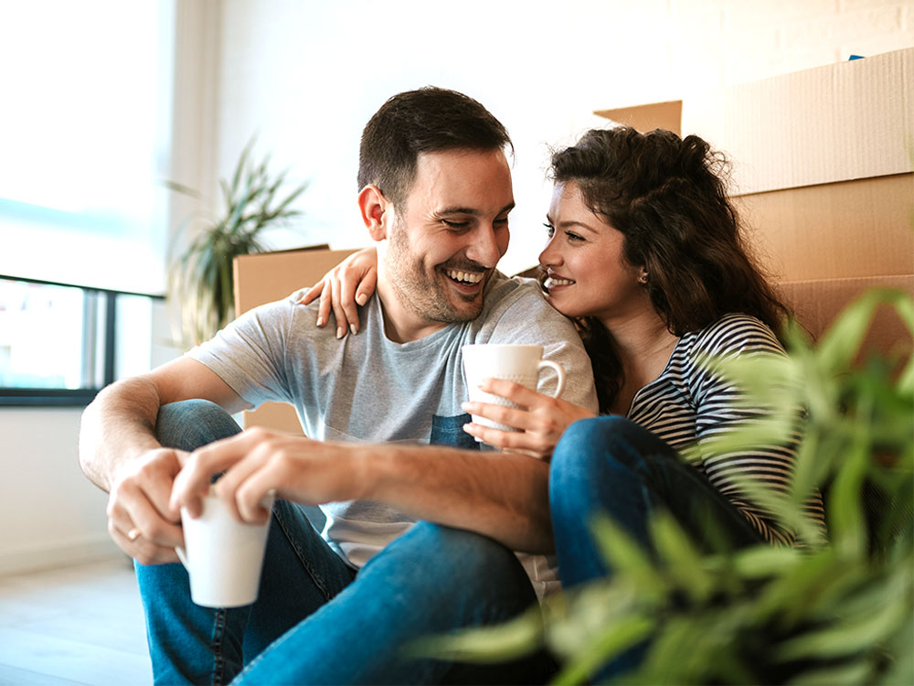 Young couple protecting their personal belongings in a new home with tenant's contents insurance