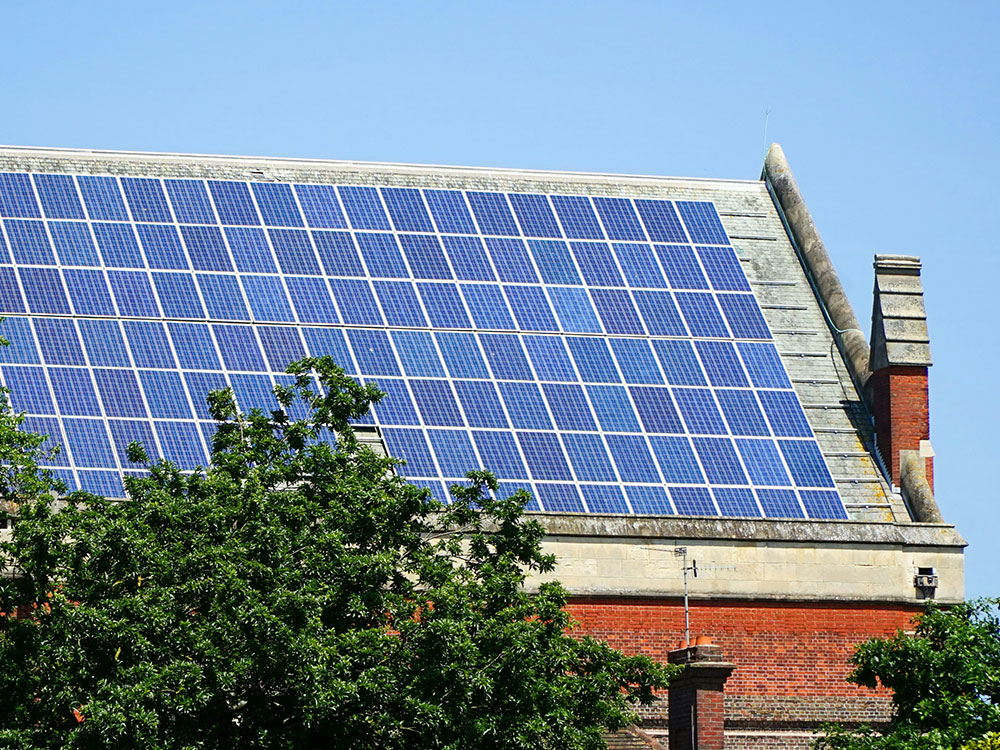 Large solar PV panel installation on a building roof provided through decarbonisation procurement solutions